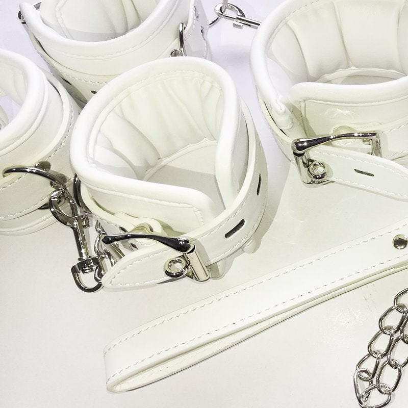 White Stuffed Leather Handcuffs and Legcuffs Close Up