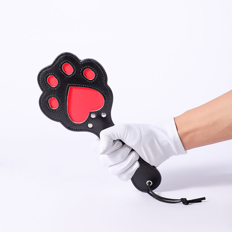 Hand Holding Red & Black Paw Paddle